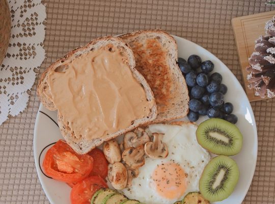bread with sliced fruits on white ceramic plate