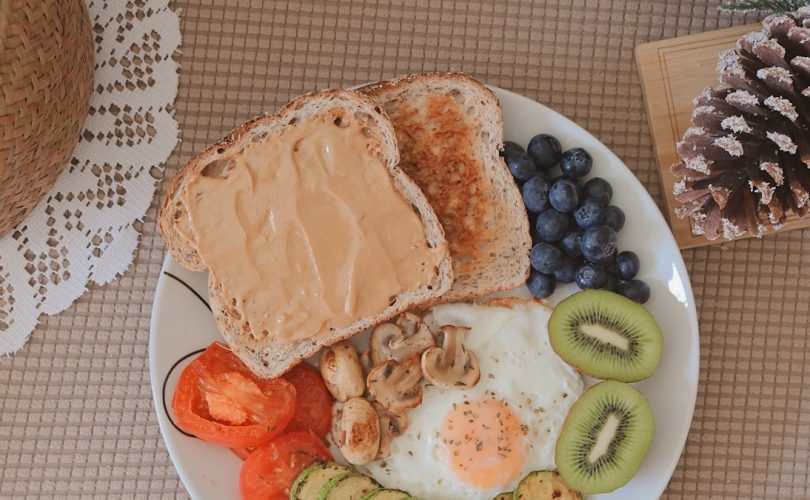 bread with sliced fruits on white ceramic plate